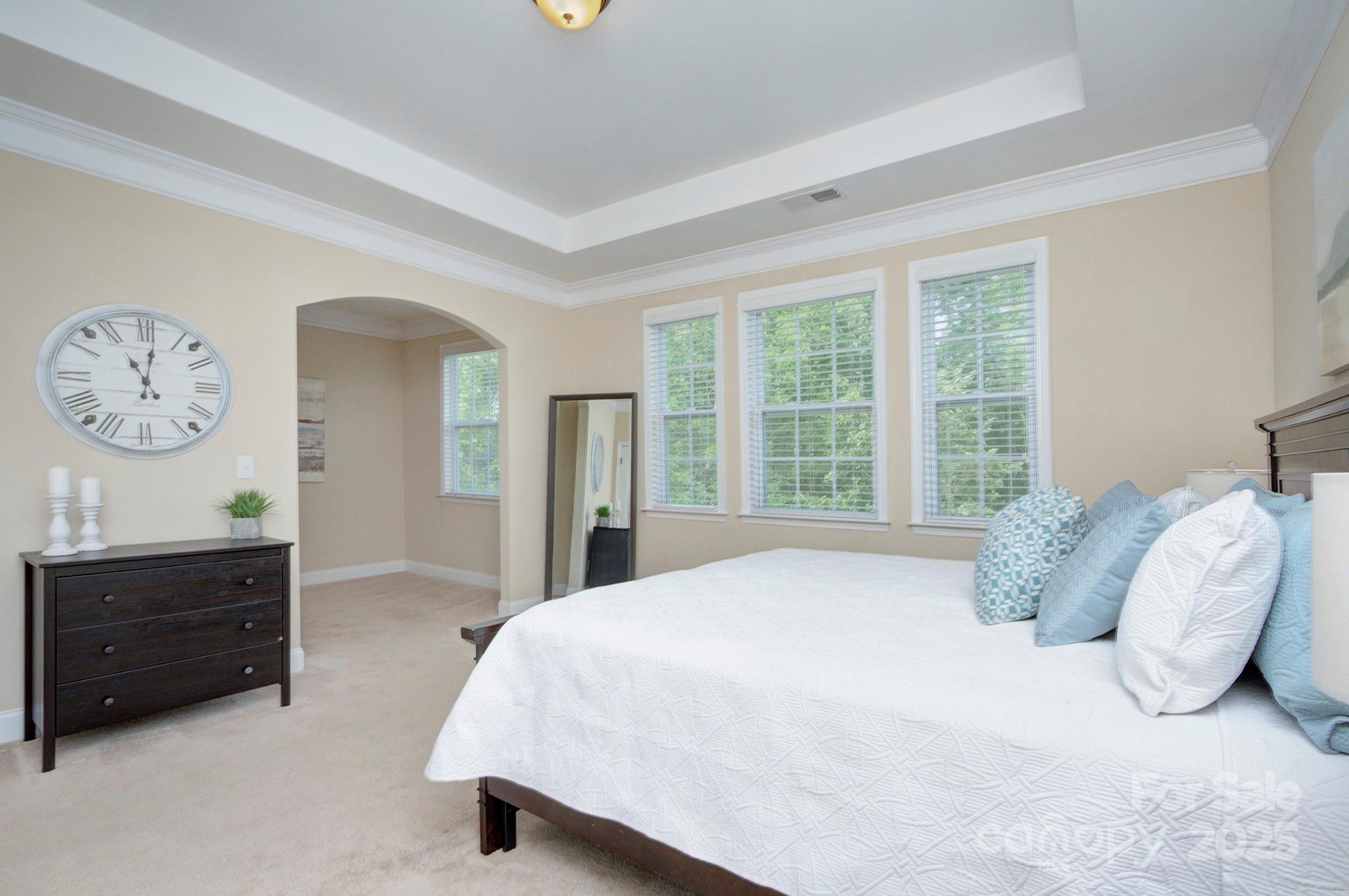 317 Annatto Way Tega Cay, SC 29708 - Photo 19 of 44 a bedroom with a bed a dresser and a large window