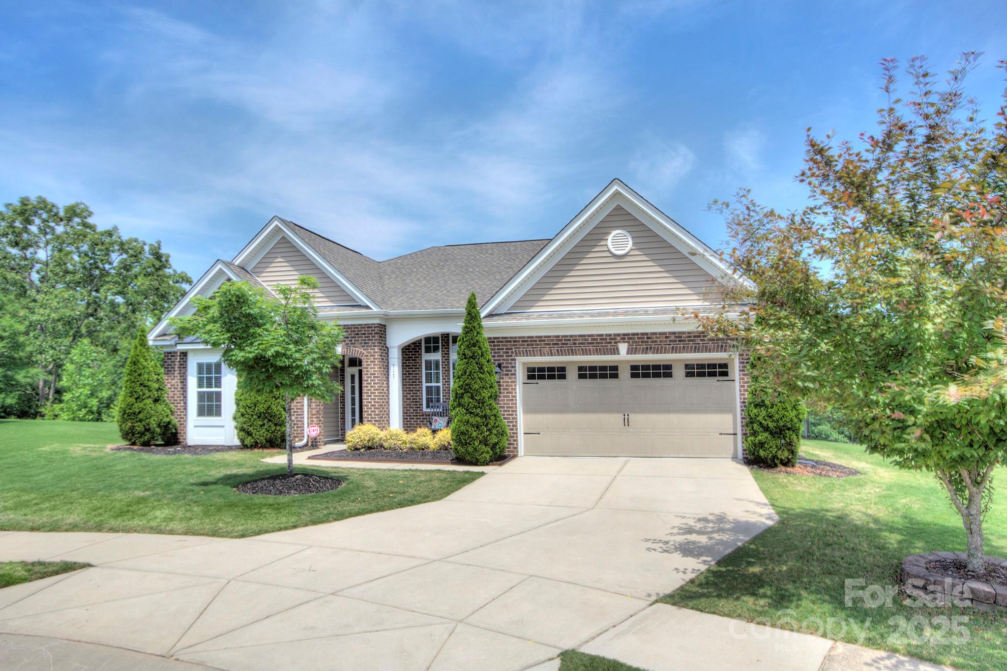 317 Annatto Way Tega Cay, SC 29708 - Photo 2 of 44 a front view of house with yard and green space