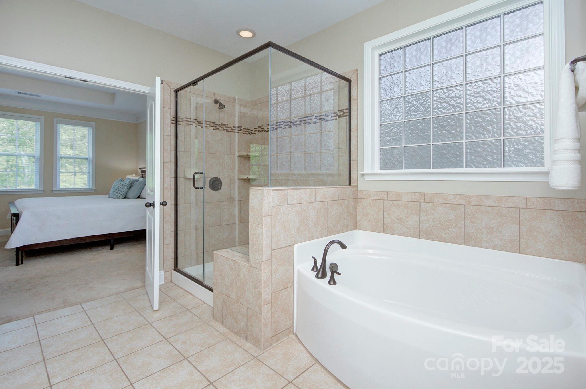 317 Annatto Way Tega Cay, SC 29708 - Photo 21 of 44 a bathroom with a bathtub and a shower