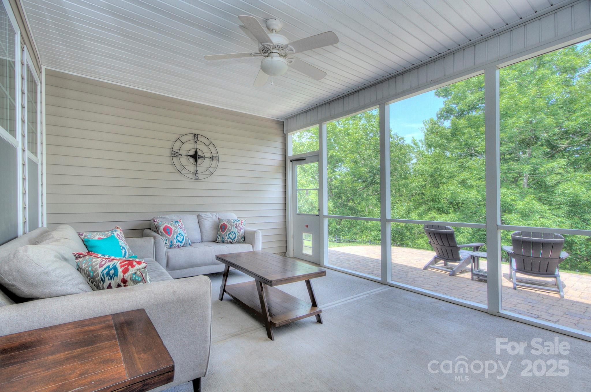 317 Annatto Way Tega Cay, SC 29708 - Photo 29 of 44 a living room with furniture and a floor to ceiling window