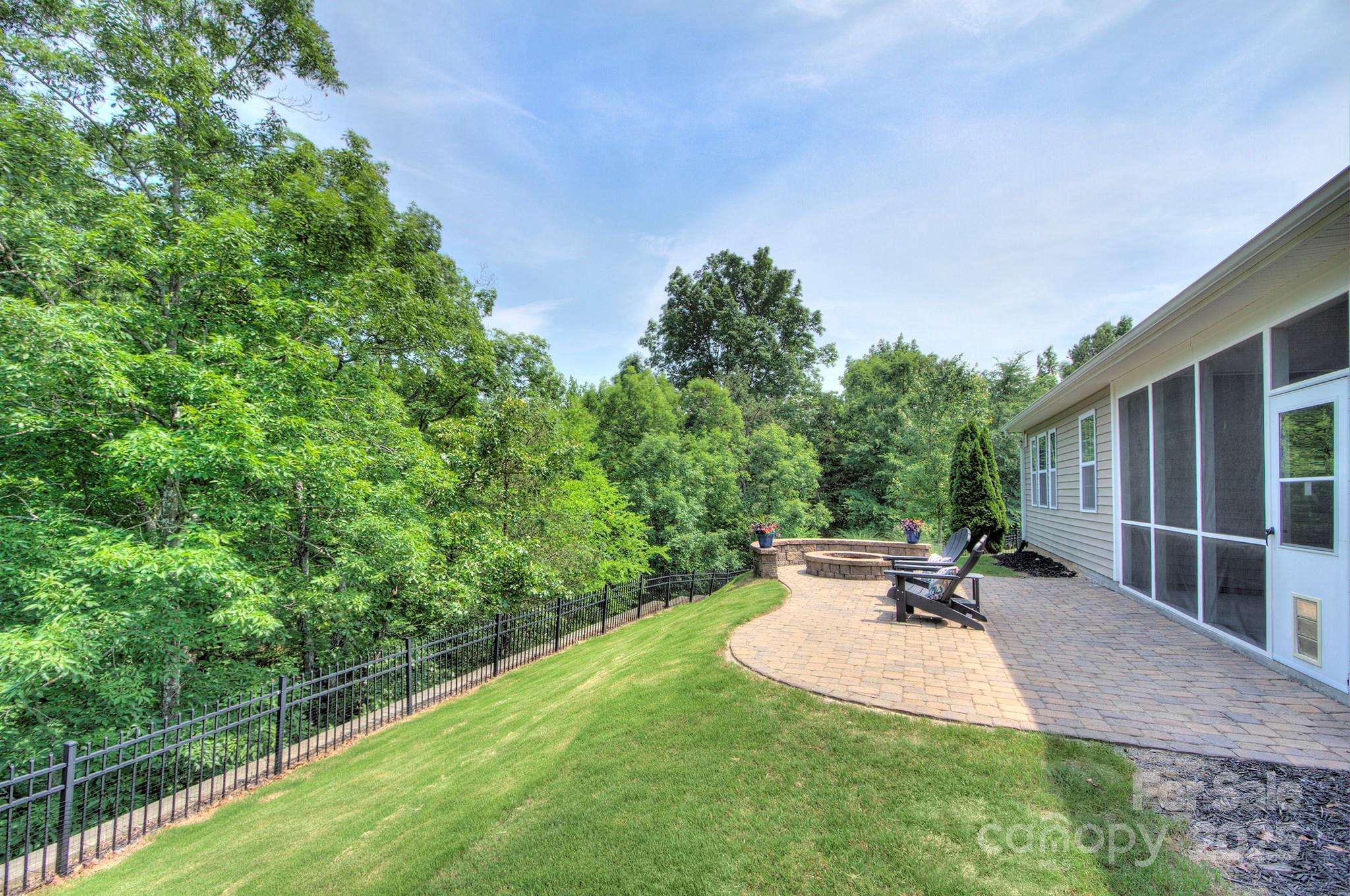 317 Annatto Way Tega Cay, SC 29708 - Photo 31 of 44 a view of a backyard with seating area