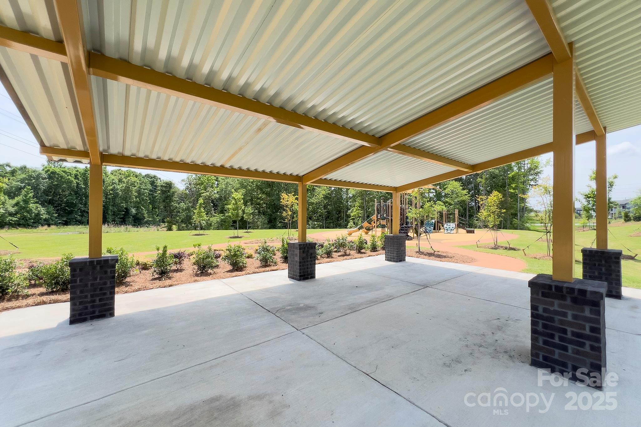 317 Annatto Way Tega Cay, SC 29708 - Photo 42 of 44 a view of a patio with a table and chairs