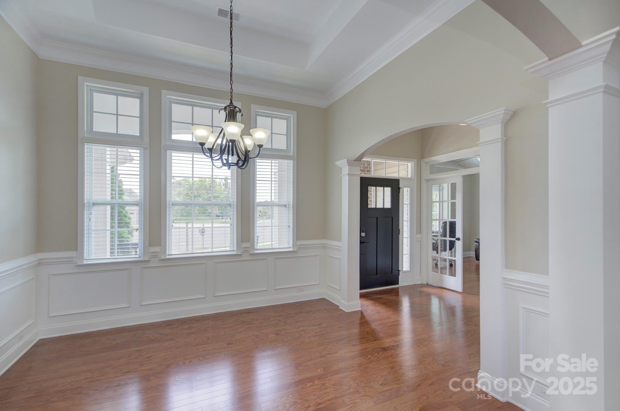 317 Annatto Way Tega Cay, SC 29708 - Photo 6 of 44 a view of an empty room with wooden floor and a window