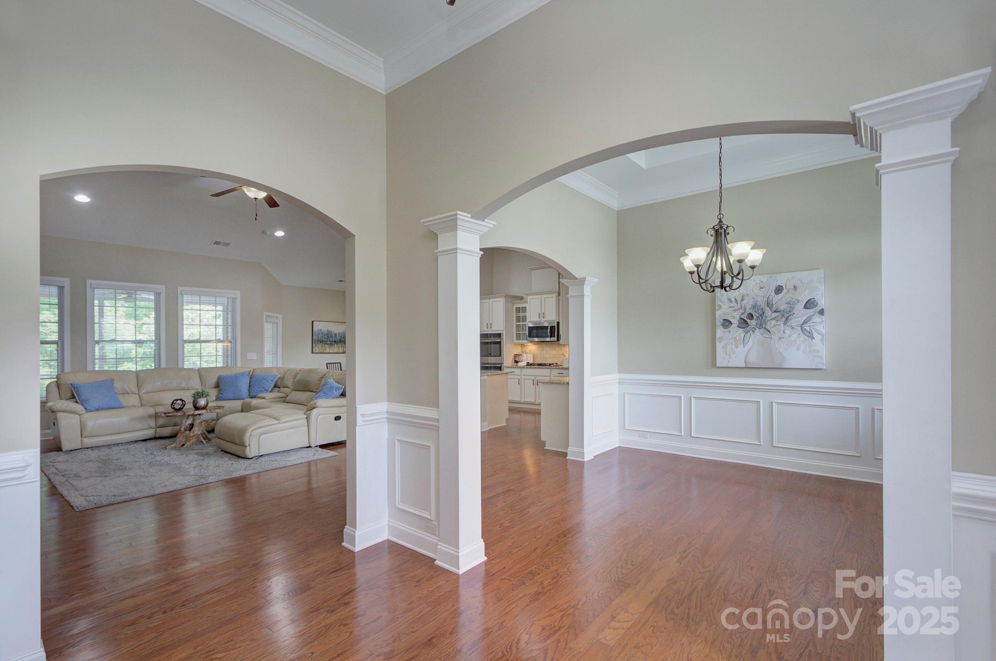 317 Annatto Way Tega Cay, SC 29708 - Photo 7 of 44 a living room with kitchen island granite countertop furniture and a chandelier