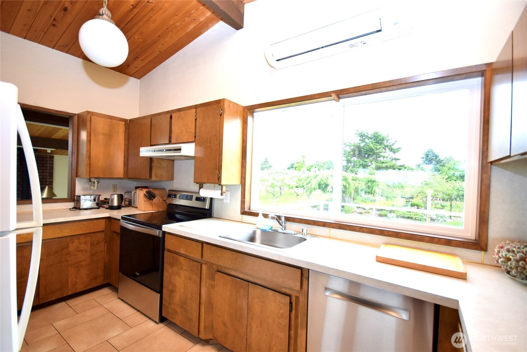 330 East Anderson Road Sequim, WA 98382 - Photo 13 of 33 a kitchen with a sink stove and cabinets