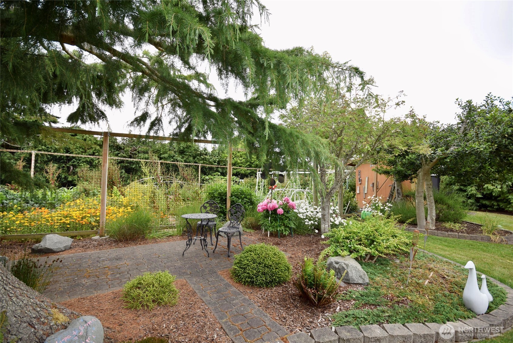 330 East Anderson Road Sequim, WA 98382 - Photo 26 of 33 a garden with plants and large trees