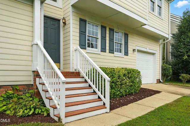 a view of a house with wooden fence
