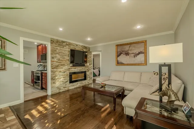 a living room with furniture a flat screen tv and a fireplace