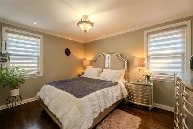 a bedroom with a bed and a potted plant