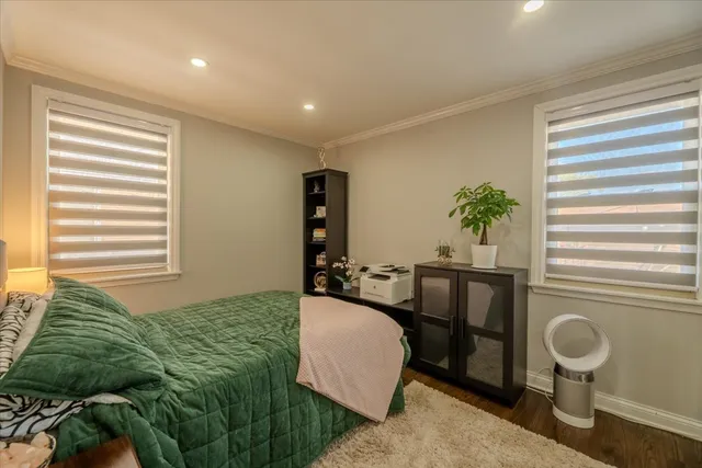 a bedroom with a bed and a potted plant