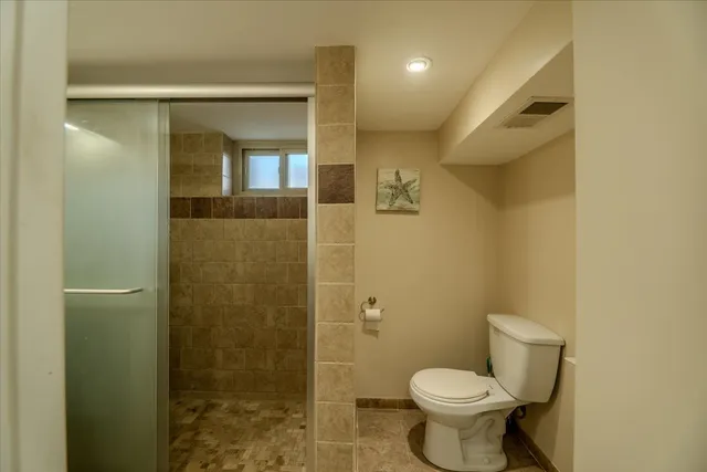 a bathroom with a sink mirror and shower