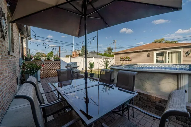 a view of a house with swimming pool and sitting area