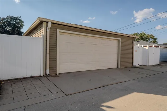 an aerial view of a house with garden space and street view