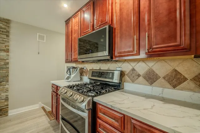a kitchen with wooden cabinets and a stove top oven