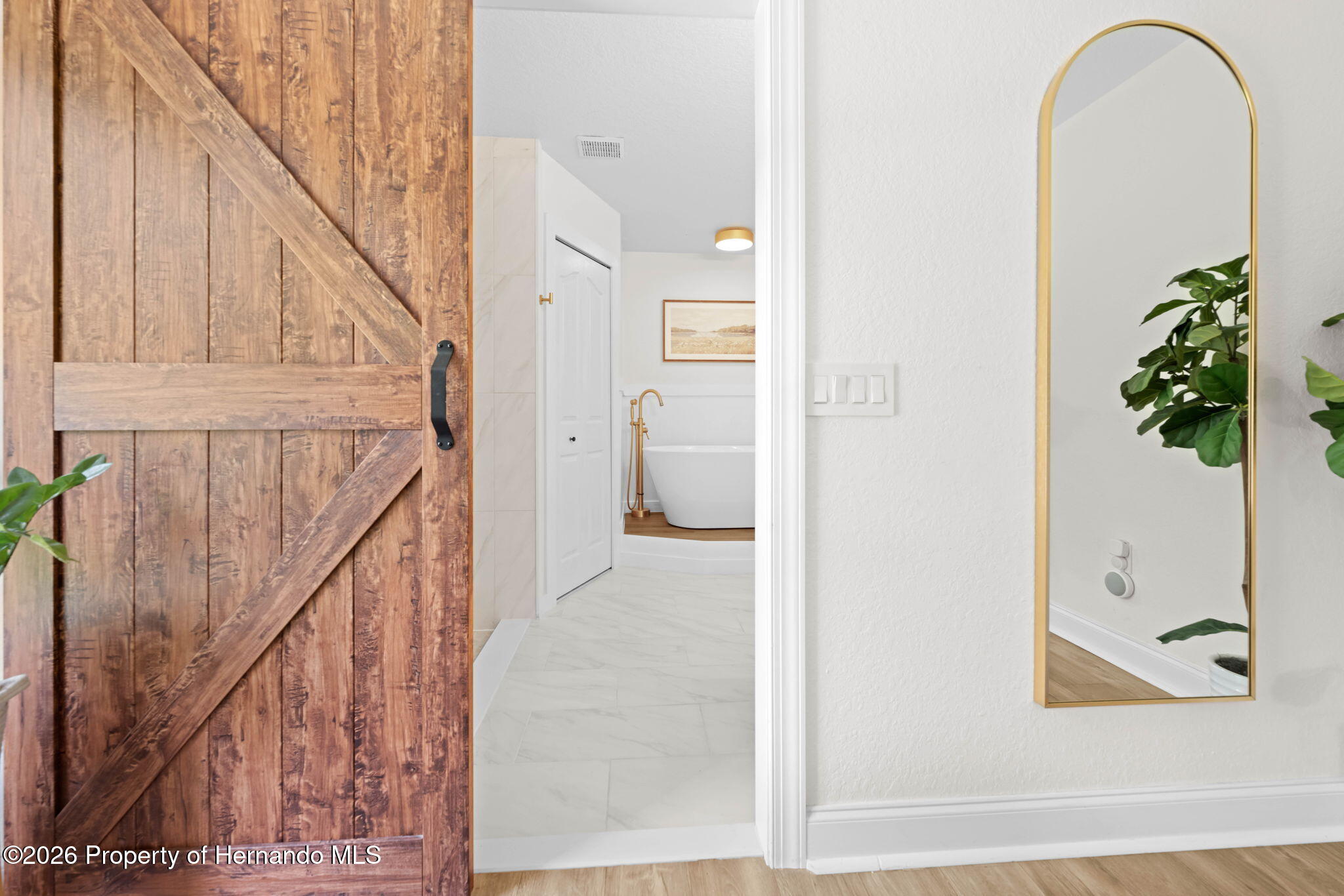 14220 Ermine Owl Road Brooksville, FL 34614 - Photo 29 of 54 a view of a hallway with wooden floor and staircase