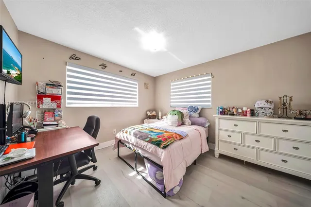 a bedroom with a bed and a television