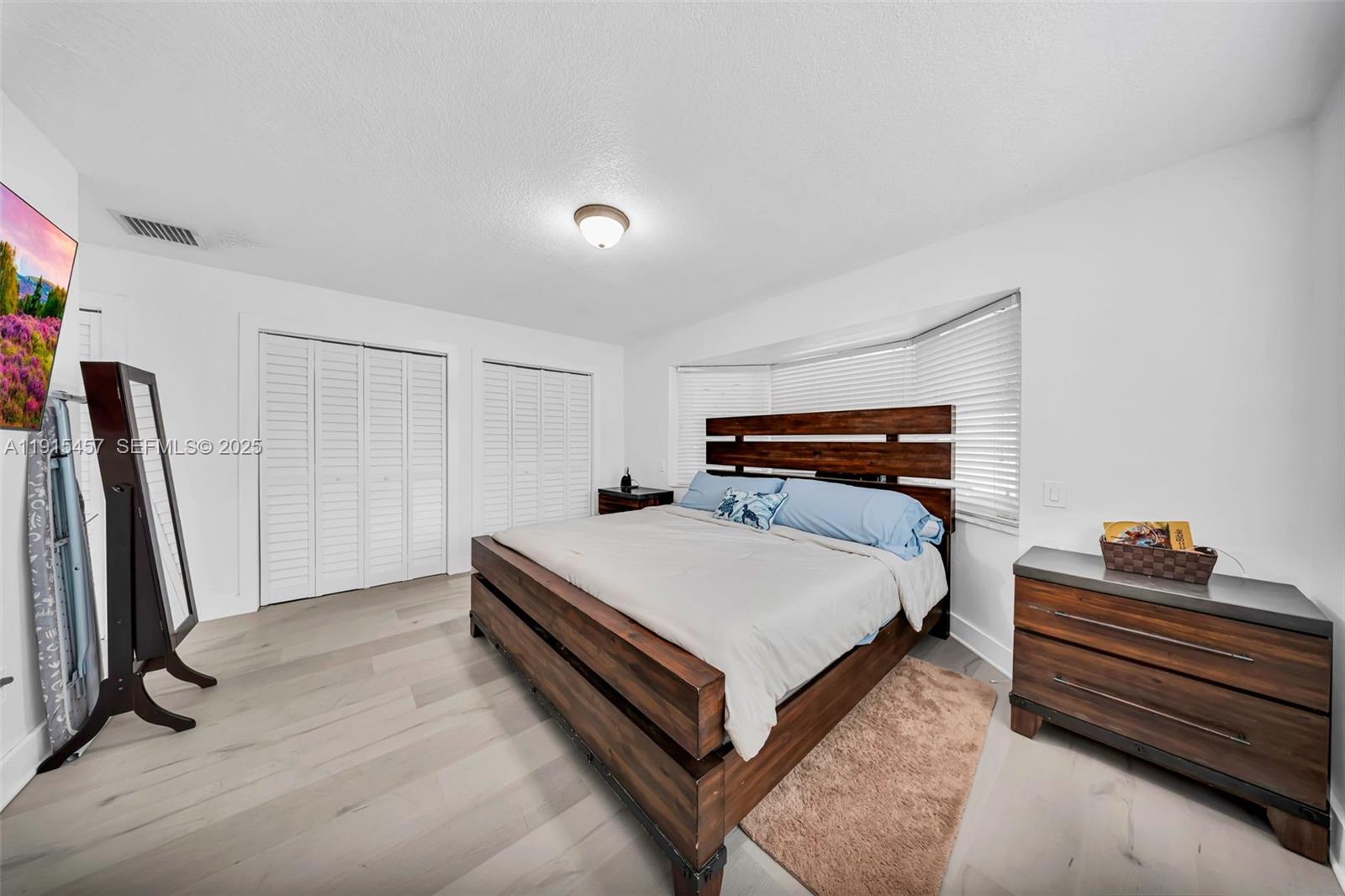 10431 Southwest 93rd Street Miami, FL 33176 - Photo 23 of 76 a bedroom with a bed and a walk in closet