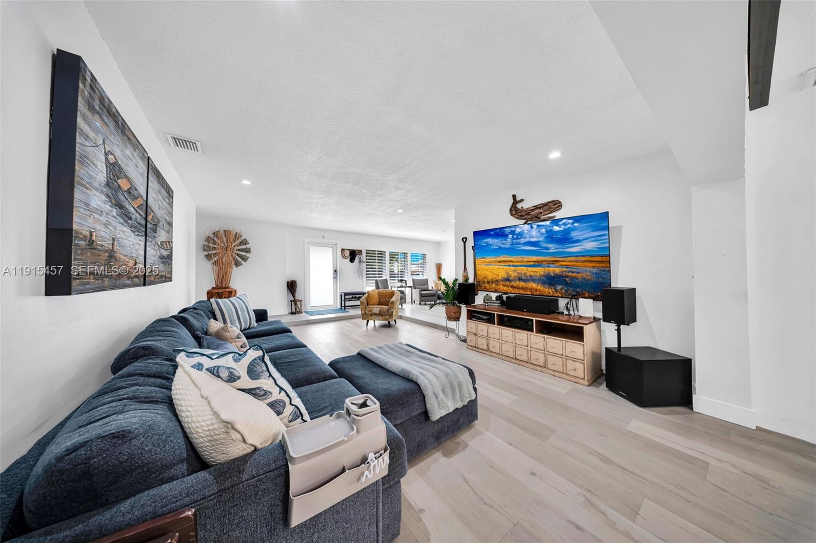 10431 Southwest 93rd Street Miami, FL 33176 - Photo 28 of 76 a living room with furniture and a flat screen tv