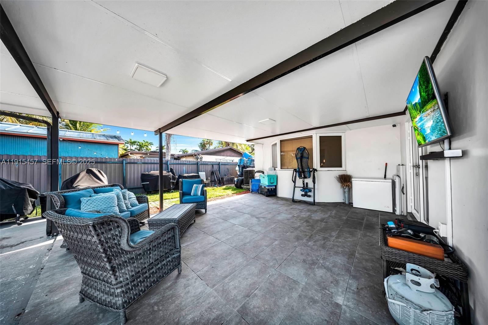 10431 Southwest 93rd Street Miami, FL 33176 - Photo 37 of 76 a living room with furniture and a flat screen tv