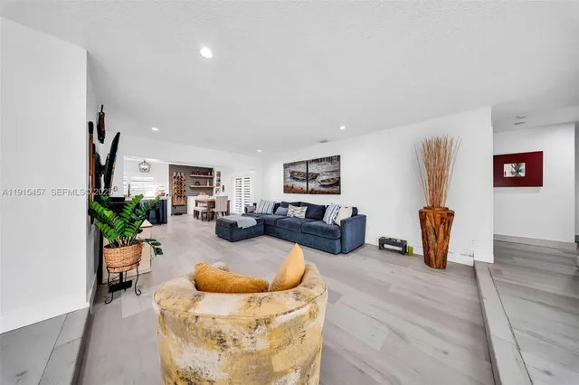 a living room with furniture fireplace and a large window