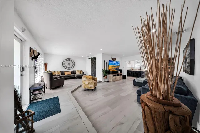 a view of a livingroom with a hardwood floor and a window