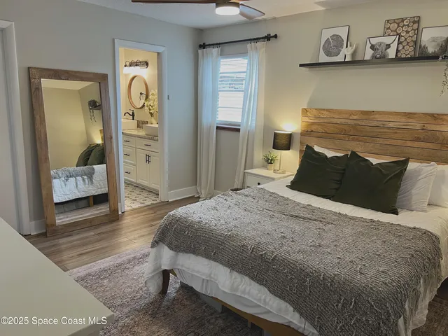 a bedroom with a bed and wall painting