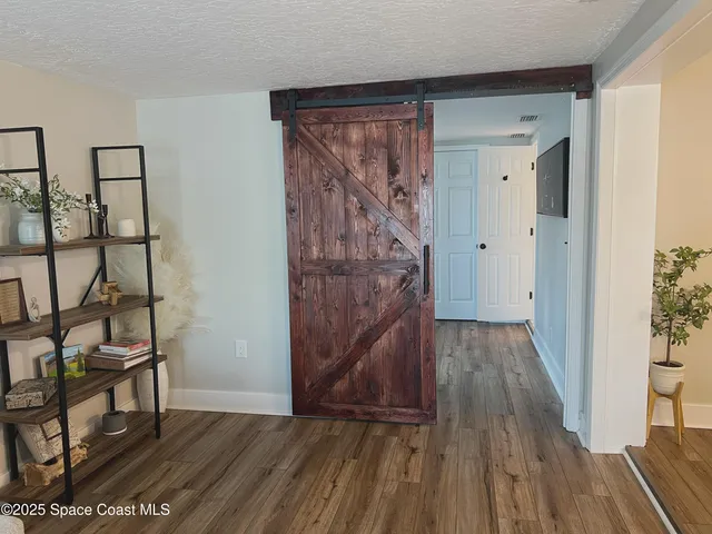 a view of hallway with wooden floor and stairs
