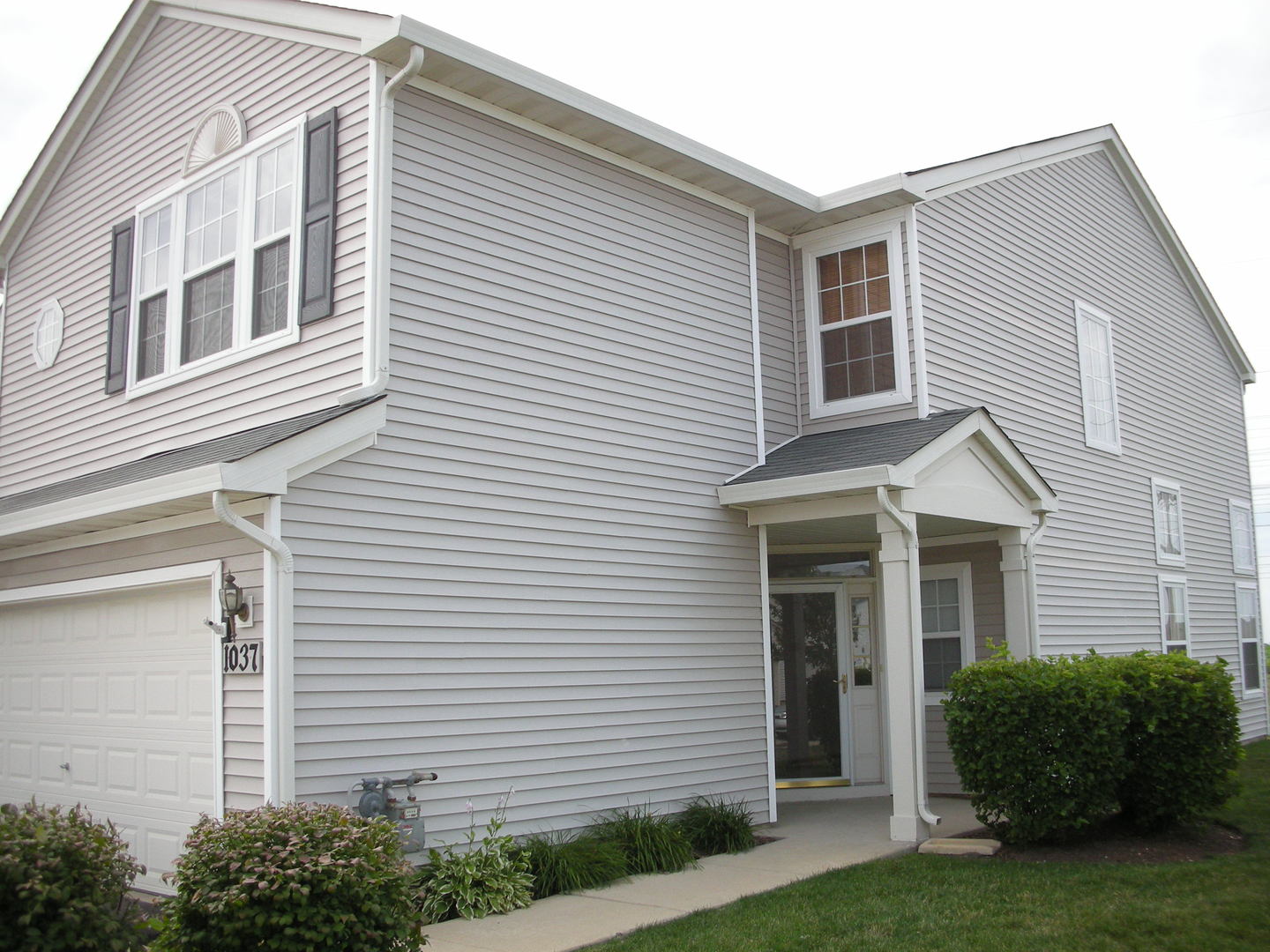 1037 Key Largo Drive Romeoville, IL 60446 - Photo 1 of 23 a front view of a house with a yard