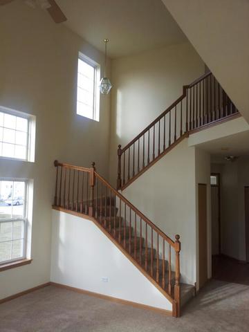 1037 Key Largo Drive Romeoville, IL 60446 - Photo 13 of 23 a view of staircase with railing and a window