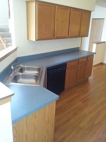 1037 Key Largo Drive Romeoville, IL 60446 - Photo 7 of 23 a kitchen with a sink and cabinets