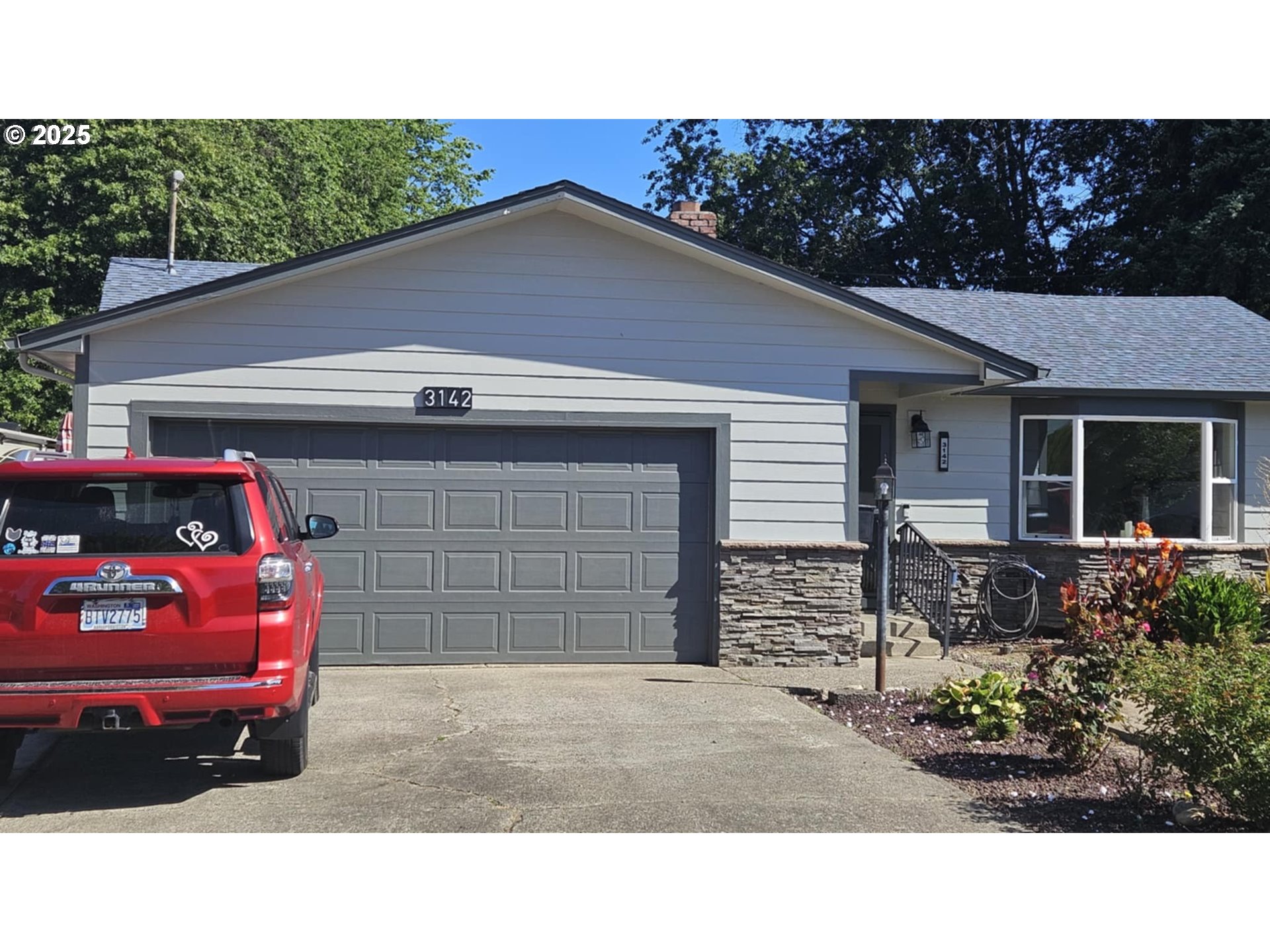3142 Maple Street Longview, WA 98632 - Photo 1 of 15 a front view of a house with a garage
