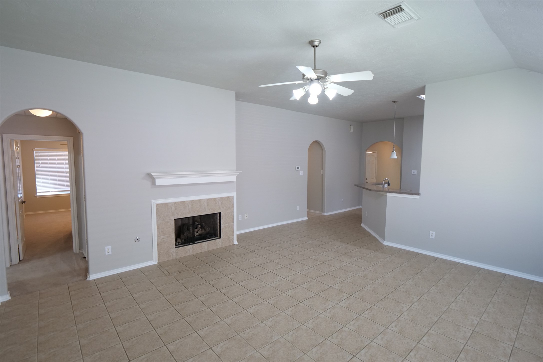 5414 Trammel Drive Spring, TX 77388 - Photo 11 of 28 an empty room with chandelier fan and fireplace