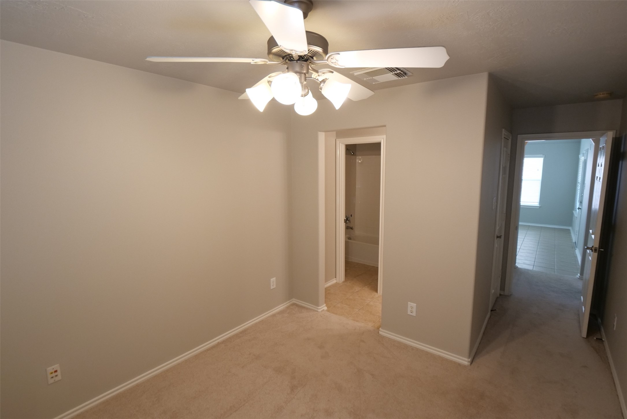 5414 Trammel Drive Spring, TX 77388 - Photo 17 of 28 a view of an empty room with a chandelier fan