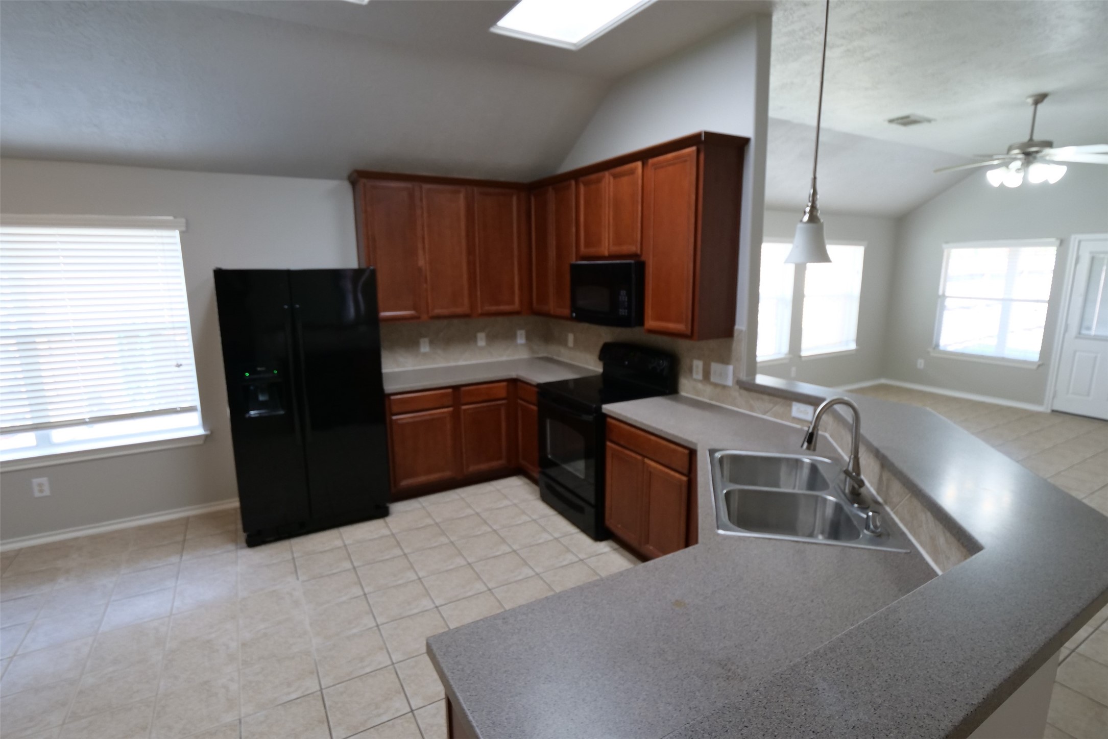 5414 Trammel Drive Spring, TX 77388 - Photo 7 of 28 a kitchen with stainless steel appliances granite countertop a refrigerator a sink a stove with wooden cabinets