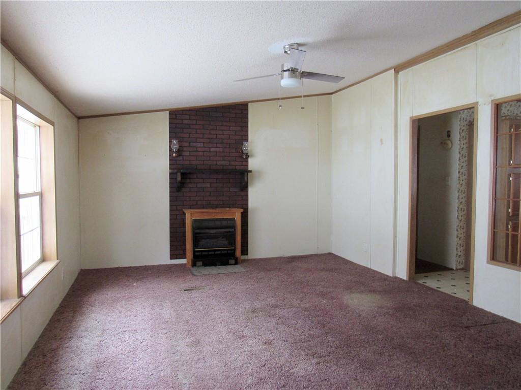 121 Hoy Run Road Spraggs, PA 15362 - Photo 8 of 25 a view of an empty room with a fireplace and a window