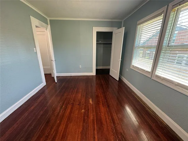 a view of a room with wooden floor and window