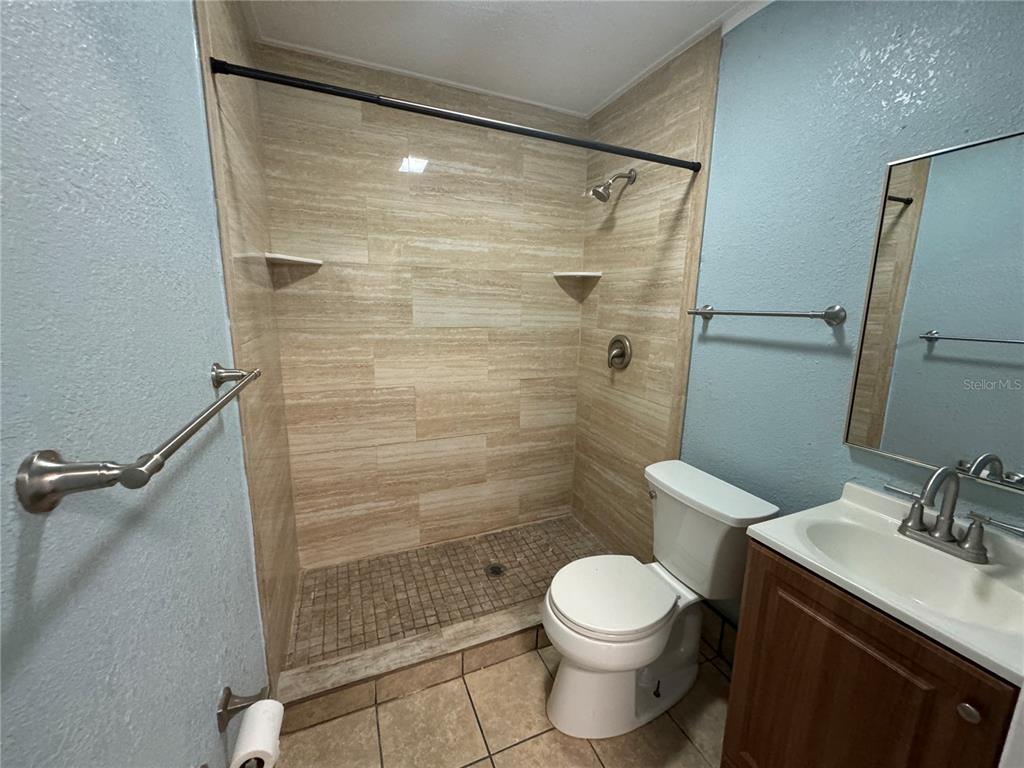 348 South Central Avenue, Unit U Umatilla, FL 32784 - Photo 12 of 13 a bathroom with a shower toilet and sink