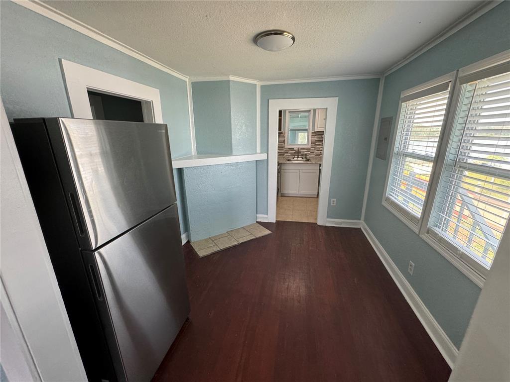 348 South Central Avenue, Unit U Umatilla, FL 32784 - Photo 5 of 13 a view of kitchen with furniture refrigerator and window