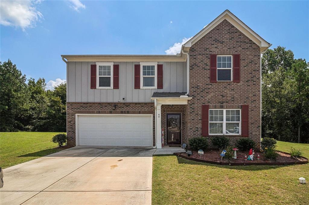 40 Suzy Court Covington, GA 30016 - Photo 1 of 1 a front view of a house with a yard garage and outdoor seating