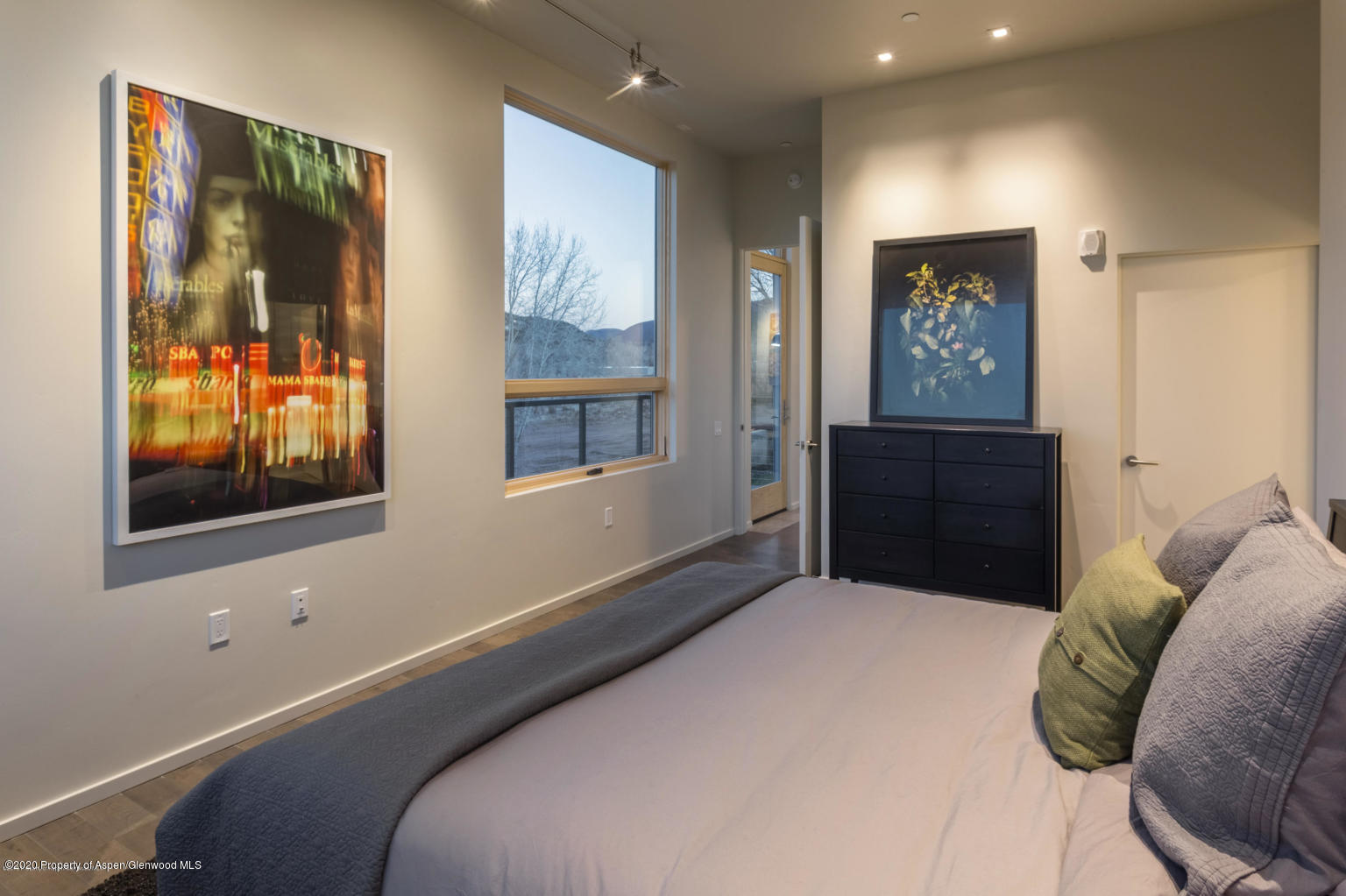 101 Willits Lane, Unit 107 Basalt, CO 81621 - Photo 9 of 16 a bedroom with a bed and a painting on the wall