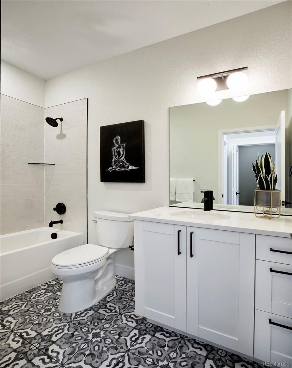 2951 East Evans Avenue Denver, CO 80210 - Photo 16 of 39 a bathroom with a sink toilet a mirror and shower