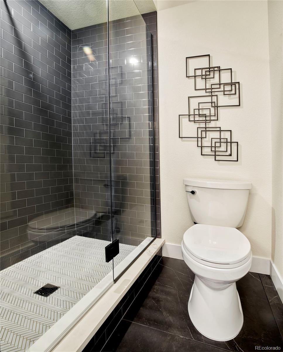 2951 East Evans Avenue Denver, CO 80210 - Photo 17 of 39 a bathroom with a sink toilet and shower