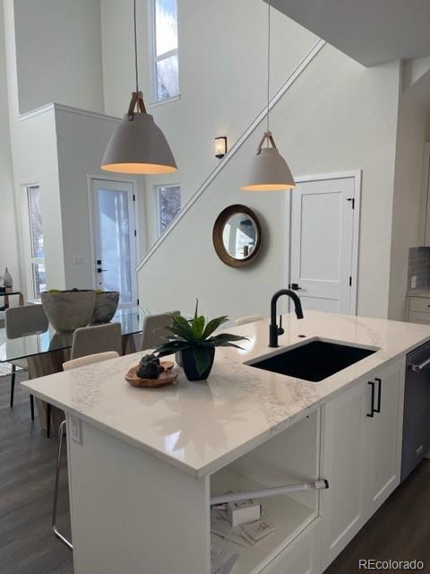 2951 East Evans Avenue Denver, CO 80210 - Photo 29 of 39 a kitchen with a sink a clock and cabinets