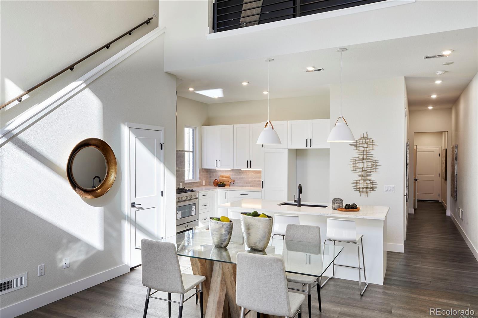2951 East Evans Avenue Denver, CO 80210 - Photo 3 of 39 a kitchen with a dining table chairs and a refrigerator