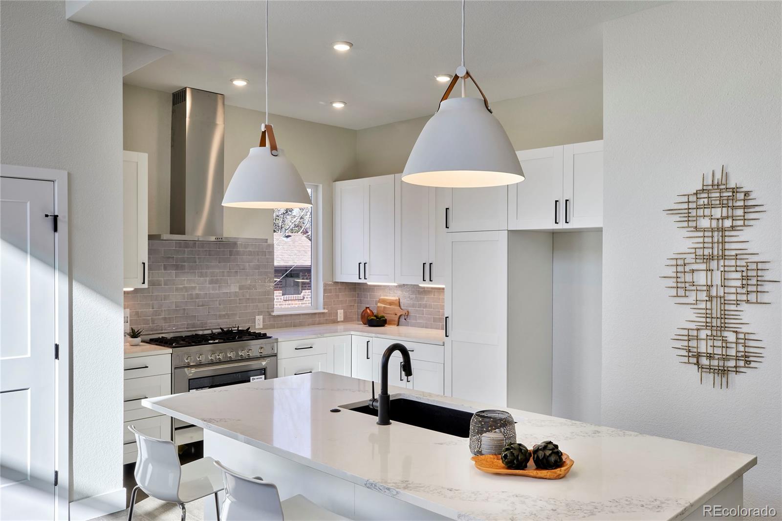 2951 East Evans Avenue Denver, CO 80210 - Photo 4 of 39 a kitchen with granite countertop a sink stove and cabinets