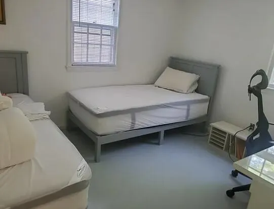 a bedroom with a bed and a window