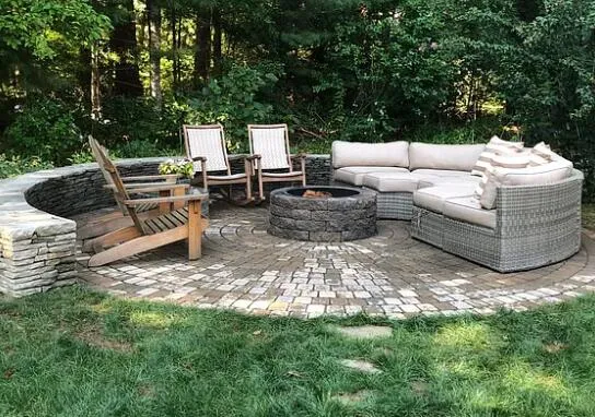 a view of a couches in a patio with a yard