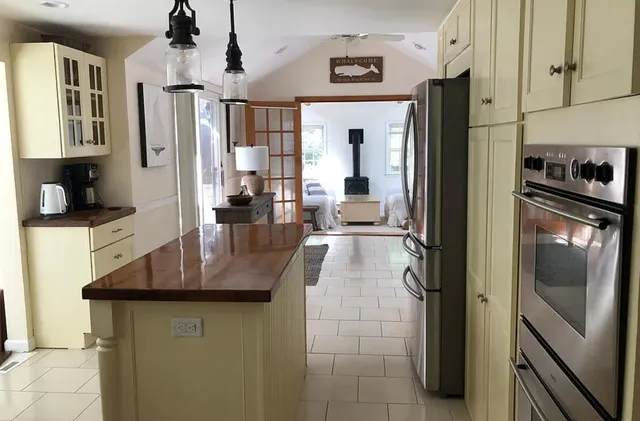 a kitchen with stainless steel appliances granite countertop a refrigerator and a sink