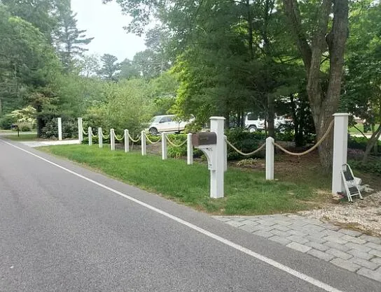 a view of a house with a yard and park