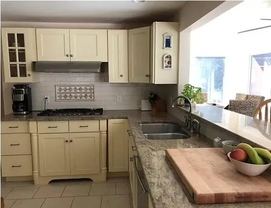 a kitchen with cabinets and window